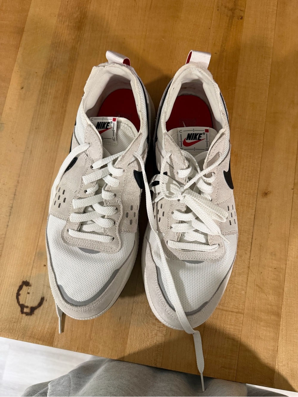 Nike White Sneakers with Black Swoosh and Red Insole Accents